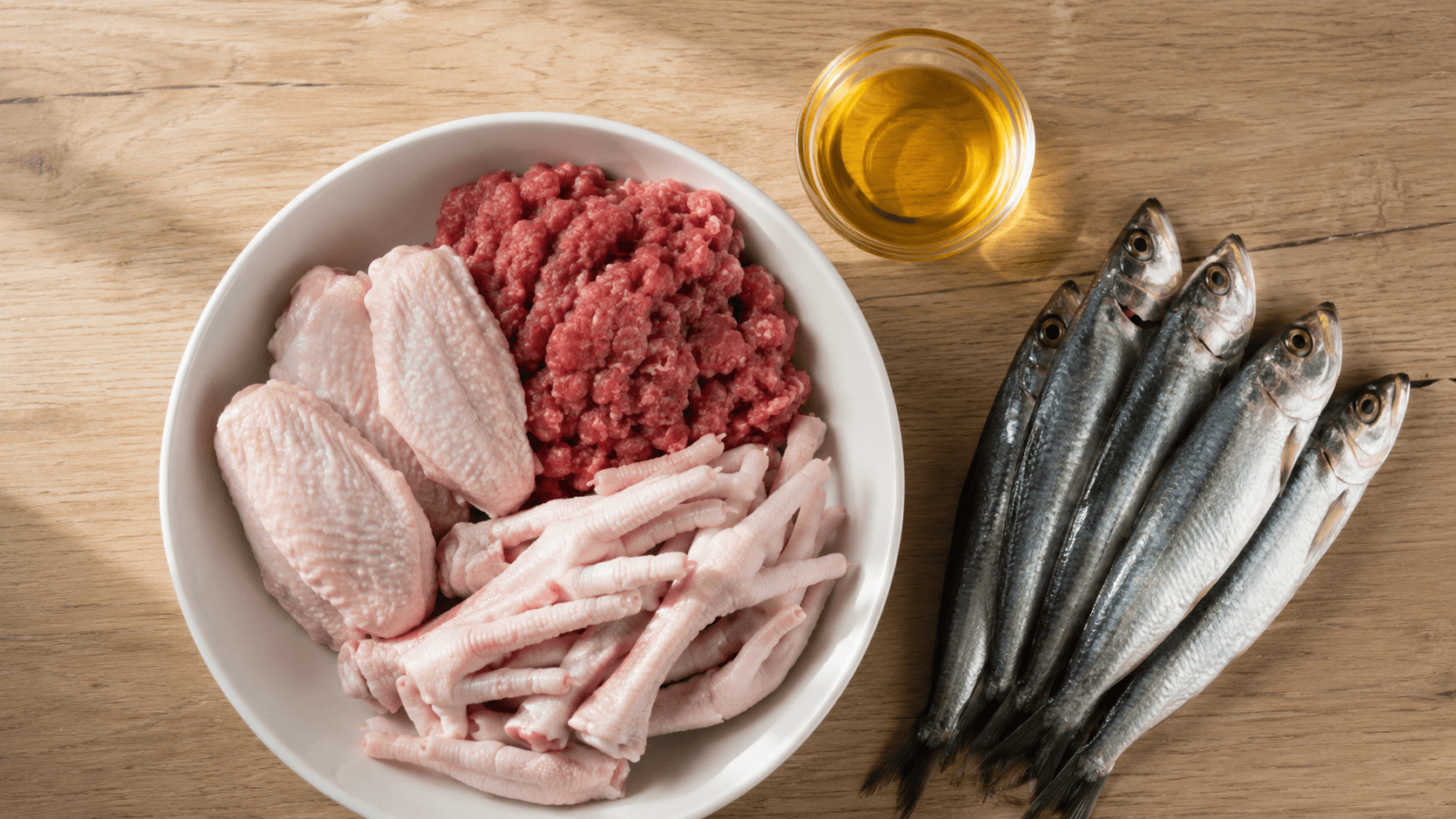 Raw feeding senior dogs a bowl of fresh raw chicken and lamb on a wooden surface
